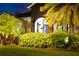 Inviting front entrance illuminated with lush landscaping, creating a warm ambiance at 6927 Crestpoint Dr, Apollo Beach, FL 33572
