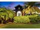 Attractive home with lush landscaping, mature palm trees, and a well-maintained lawn at 6927 Crestpoint Dr, Apollo Beach, FL 33572