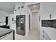 Hallway with cabinetry, stainless steel refrigerator, and access to other rooms in the home at 6927 Crestpoint Dr, Apollo Beach, FL 33572