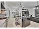 Well-appointed kitchen with an island, stainless steel sink, and open views to the living area at 6927 Crestpoint Dr, Apollo Beach, FL 33572