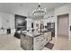 Open-concept kitchen features a center island with a sink and stainless steel appliances, seamlessly connecting to the living room at 6927 Crestpoint Dr, Apollo Beach, FL 33572