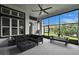 Spacious screened-in lanai with outdoor seating, dining area, and views of lush landscaping at 6927 Crestpoint Dr, Apollo Beach, FL 33572