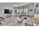 Spacious living room featuring a large sectional sofa and light-filled windows at 6927 Crestpoint Dr, Apollo Beach, FL 33572
