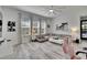 Bright living room with a large sectional sofa, light wood floors, and modern decor at 6927 Crestpoint Dr, Apollo Beach, FL 33572