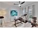 Bright home office featuring a desk, exercise equipment and natural light from two large windows at 6927 Crestpoint Dr, Apollo Beach, FL 33572