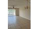 Spacious living room with tiled floors and a sliding glass door to a balcony at 1 Boca Ciega Point Blvd # 211, St Petersburg, FL 33708