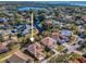 Stunning aerial view of home with lake and waterfront access in a beautiful, serene community at 1010 Blue Heron Way, Tarpon Springs, FL 34689