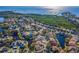 Aerial view of community homes, ponds and lush green space with waterfront at 1010 Blue Heron Way, Tarpon Springs, FL 34689