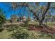 Spacious backyard with a hammock under a large shade tree, near waterfront at 1010 Blue Heron Way, Tarpon Springs, FL 34689