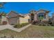 Inviting single-story home with beautiful landscaping and a well-maintained lawn at 1010 Blue Heron Way, Tarpon Springs, FL 34689