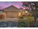 Charming single-story home with a well-manicured lawn and a two-car garage at 1010 Blue Heron Way, Tarpon Springs, FL 34689
