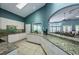 Well-equipped kitchen with granite countertops, white cabinets, stainless appliances and tiled floors at 1010 Blue Heron Way, Tarpon Springs, FL 34689