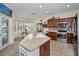 Spacious kitchen with stainless steel appliances and natural light, next to a dining area at 1010 Blue Heron Way, Tarpon Springs, FL 34689