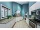 Modern kitchen featuring white cabinets, granite countertops, stainless appliances, and tile floors at 1010 Blue Heron Way, Tarpon Springs, FL 34689