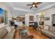 Inviting living room with hardwood floors and an open layout with views of the kitchen and front door at 1010 Blue Heron Way, Tarpon Springs, FL 34689