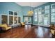Bright lobby with hardwood floors, decorative lighting, comfortable seating, and a wall of windows at 1010 Blue Heron Way, Tarpon Springs, FL 34689
