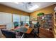 Cozy meeting room with a conference table, comfortable chairs, and a bookshelf filled with reading selections at 1010 Blue Heron Way, Tarpon Springs, FL 34689