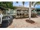 Outdoor patio with a grill and seating area, perfect for entertaining with views of the lush landscaping at 1010 Blue Heron Way, Tarpon Springs, FL 34689