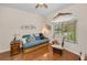Sitting room with hardwood floors, an arched window with blinds, a ceiling fan, and comfortable seating at 1010 Blue Heron Way, Tarpon Springs, FL 34689