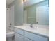 Bright bathroom with a large mirror, a white sink, and a shower-tub combo at 1020 New Winsor Loop # 46, Sun City Center, FL 33573