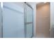 Walk-in shower with glass doors and all-white tile work at 1020 New Winsor Loop # 46, Sun City Center, FL 33573