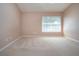 Large bedroom with carpet, neutral paint, large window, and ceiling fan at 1020 New Winsor Loop # 46, Sun City Center, FL 33573