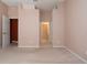 Bedroom with neutral paint and carpet leading to hallway with linen closet at 1020 New Winsor Loop # 46, Sun City Center, FL 33573