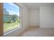 Sunny bedroom features natural light, plush carpet, and an expansive view of the neighborhood at 1020 New Winsor Loop # 46, Sun City Center, FL 33573