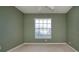 A clean bedroom with neutral carpet and a window offering natural light at 1020 New Winsor Loop # 46, Sun City Center, FL 33573