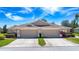 Exterior full frontal view of charming residences, each equipped with private two-car garages and convenient driveway parking at 1020 New Winsor Loop # 46, Sun City Center, FL 33573