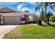 Charming single-story home boasts a well-manicured lawn, mature landscaping, and a two-car garage at 1020 New Winsor Loop # 46, Sun City Center, FL 33573