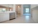 Well-lit kitchen with stainless steel dishwasher and breakfast bar area at 1020 New Winsor Loop # 46, Sun City Center, FL 33573