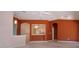 Open-concept living room with terra cotta-colored walls that connects the kitchen and features neutral carpet at 1020 New Winsor Loop # 46, Sun City Center, FL 33573