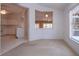 Open living room features neutral carpet and a breakfast bar with convenient access to the adjacent kitchen at 1020 New Winsor Loop # 46, Sun City Center, FL 33573