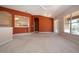 Bright living room features sliding glass door, terra cotta colored walls, and view to connected kitchen at 1020 New Winsor Loop # 46, Sun City Center, FL 33573