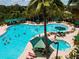 Expansive community pool featuring lounge chairs, umbrellas, and a relaxing hot tub for ultimate leisure at 1020 New Winsor Loop # 46, Sun City Center, FL 33573