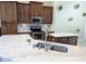 Bright kitchen features marble countertops, stainless steel appliances, and wood cabinets at 1032 S Pointe Alexis Dr, Tarpon Springs, FL 34689