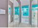 Hallway view of a vibrant bathroom with double mirrors and a large soaking tub at 1034 Mcdaniel St # 1034, Sun City Center, FL 33573