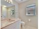 Bathroom with tiled wall design, neutral flooring, and bright lighting with a window view at 1034 Mcdaniel St # 1034, Sun City Center, FL 33573