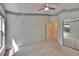 Neutral bedroom featuring carpet, ceiling fan, large closet and a blue and green patterned border at 1034 Mcdaniel St # 1034, Sun City Center, FL 33573