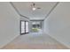 Spacious bedroom with plush carpet, ceiling fan, and glass doors leading to the outside at 1034 Mcdaniel St # 1034, Sun City Center, FL 33573