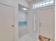 Bright foyer featuring ceramic tile floor, a transom window and a view into the adjacent living room at 1034 Mcdaniel St # 1034, Sun City Center, FL 33573