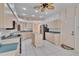 Bright kitchen featuring tile floors, wood cabinets, center island, and stainless appliances at 1034 Mcdaniel St # 1034, Sun City Center, FL 33573