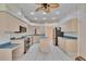 Bright kitchen featuring tile floors, wood cabinets, an island and stainless steel appliances at 1034 Mcdaniel St # 1034, Sun City Center, FL 33573