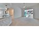 Open living room with white walls, carpet flooring and views into sunroom at 1034 Mcdaniel St # 1034, Sun City Center, FL 33573