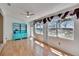 Bright living room with wood floors, a ceiling fan, and a large window with burgundy valances at 1034 Mcdaniel St # 1034, Sun City Center, FL 33573