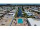 Aerial view of the neighborhood showcasing waterfront access, a community pool and well-maintained homes at 105 W Saint Johns Way, Apollo Beach, FL 33572