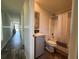 Bathroom with tub and shower combo, modern single sink vanity, and neutral finishes at 105 W Saint Johns Way, Apollo Beach, FL 33572