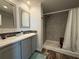 Bathroom featuring double sinks, modern fixtures, walk-in shower and neutral finishes at 105 W Saint Johns Way, Apollo Beach, FL 33572