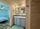 Bathroom featuring double sinks, modern fixtures, and a walk-in shower, with neutral finishes at 105 W Saint Johns Way, Apollo Beach, FL 33572